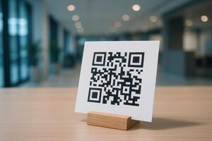 QR code on white card in wooden holder on table for digital scan and information photo