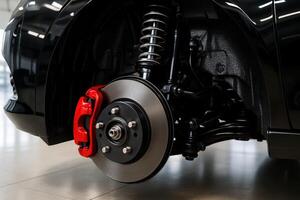 Detailed view of modern car rear suspension and disc brake system with red caliper photo
