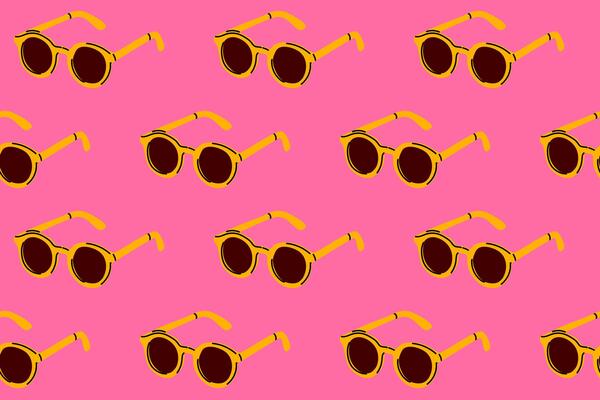 Seamless pattern of yellow glasses with dark lenses on pink background, ideal for summer accessory visuals