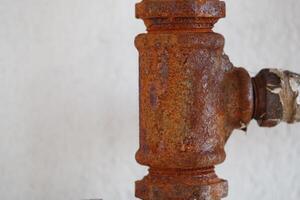 Rusty pipe fitting showing signs of age and wear photo