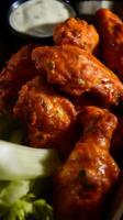 Close Up of Spicy Buffalo Chicken Wings with Celery and Ranch Dressing. photo