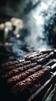Close Up of Delicious Grilled Kebabs Smoking on a Barbecue Grill. photo