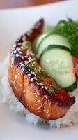 Close Up of Glazed Salmon Fillet Served with Rice and Cucumber. photo