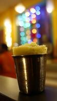 Close up of Creamy Dessert in a Metallic Cup with Bokeh Lights Background. photo