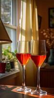 Two Glasses of Red Wine Basking in Sunlight by a Window. photo