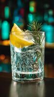 Gin and Tonic with Lemon and Rosemary Garnish in Crystal Glass. A refreshing cocktail ready to be enjoyed. photo