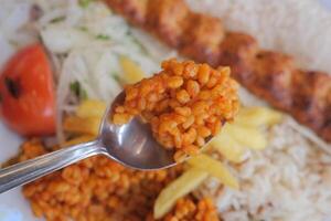 Delicious meal featuring rice and kebabs served on a plate photo