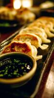 Close up of Pan-Fried Gyoza Dumplings with Dipping Sauce. A delicious Asian food image perfect for culinary websites and blogs. photo