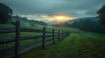 Serene Sunrise over Misty Mountain Pasture with Rustic Fence. A picturesque landscape photograph capturing the tranquil beauty of a rural morning. photo