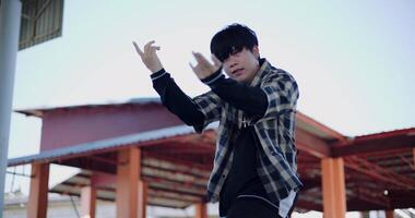 Handheld low angle view shot, Young man with dancing skills is practicing new moves by himself. Enjoy the rhythm and creativity. Solo dance. video