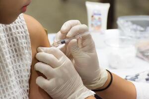 A person getting an injection from a doctor photo