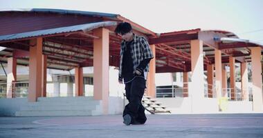 Handheld wide view shot, Young man with dancing skills is practicing new moves by himself. Holiday activity. Solo dance. video