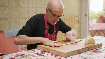 Elderly Man Relaxes Making Handmade Pasta in the Kitchen video