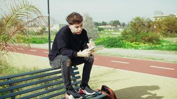Man Writing Notes With A Pen While Studying Sitting On A Bench Outdoor video