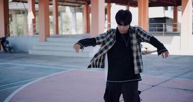 Handheld shot, Young man with dancing skills is practicing new moves by himself. Holiday activity. Solo dance. video