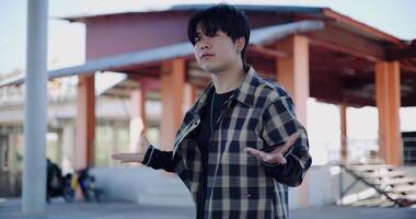 Handheld shot, Young Asian man with dancing skills is practicing new moves by himself. Enjoy the rhythm and creativity. Solo dance. video