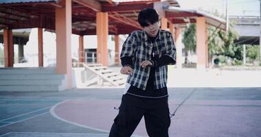 Handheld shot, Young man with dancing skills is practicing new moves by himself. Enjoy the rhythm and creativity. video