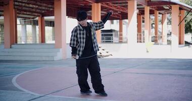Handheld wide view shot, Young man with dancing skills is practicing new moves by himself. Enjoy the rhythm and creativity. Solo dance. video