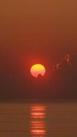 Timelapse of sunrise with orange sky in a cloudy day at the ocean. video