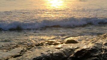The sun is setting over the ocean and waves video