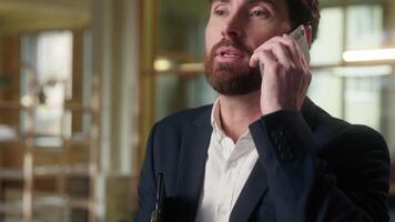 Caucasian businessman multitasking stressed male business man talking mobile phone in office busy middle-aged guy real estate agent employee answer smartphone call consulting distant communication video