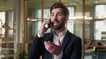 Smiling business man Caucasian middle-aged happy businessman talking mobile phone in office cheerful employer male guy professional manager call smartphone conversation friendly speaking job negotiate video