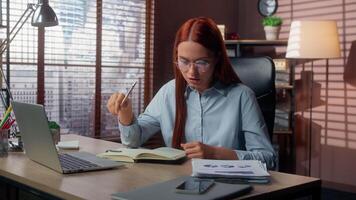 Caucasian focused businesswoman work analyzing document with chart diagram writing notes checking information confused business woman female girl analytics problem in office incorrect financial data video