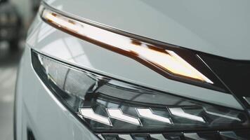 Close-up of car headlights. An advanced design concept that improves visibility, demonstrates innovation and adds style to night driving video