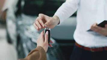 Closing the deal. Handing over the keys. The concept of the final stage of a flawless purchase, sale or test drive of a car, emphasizing the customer's satisfaction video