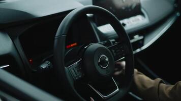 A satisfied, happy woman client sitting behind the wheel of a new car. Concept a joyful moment of car ownership, highlighting the excitement and satisfaction of a new purchase video