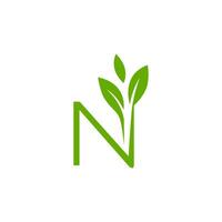 The letter n logo with green leaves vector