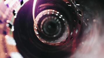 A detailed view of a film roll with visible perforations and a polished surface. Against a dark background. video