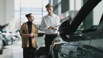 Concept a trusting dialogue between the buyer and the consultant, the decision-making process for purchasing a car. A customer at a car dealership consults with a salesperson, choosing a new vehicle. video