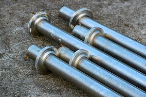 Arrangement of Metal Pipes on Concrete Surface Industrial Material photo
