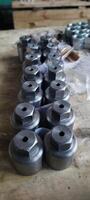 Metal components with a hexagonal head. Industrial fasteners on a wooden surface. Mechanical engineering. Is used in such fields as mechanical engineering, oil and gas, metallurgy, chemical. photo