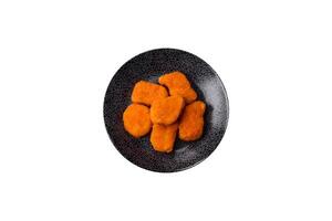 Crispy chicken nuggets, meat takeaway meal with salt, spices. Chicken nuggets, fast food photo