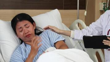Patient crying and stress. Emotional female patient lies in a hospital bed. Crying and receiving comfort from doctor. Caring vulnerability support and human connection in difficult medical situation video