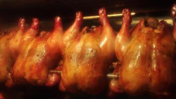 Whole marinated chicken is rolled and cooked in a large oven video