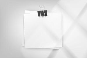 Stack of white paper stickers on bright background with window light. 3d mockup vector
