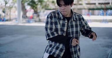 Handheld selective focus shot, Stylish young man with dancing skills, moving body coolly and stylishly to the rhythm. Solo dance. video