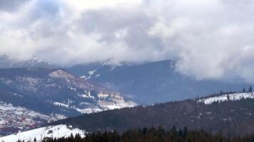 Clouds moving over snowy mountain range video