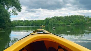 Kayak navigating on a river on a cloudy day video
