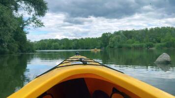 Kayaking on calm lake under cloudy sky video