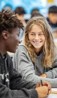 Smiling students collaborating and learning together in modern classroom photo