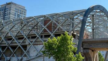 Intricate latticework weaves urban daydreams, echoing Labor Days industrious spirit in a cityscapes skeletal hug photo