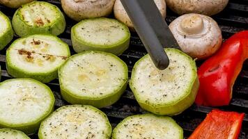 Grilled zucchini medallions and mushrooms dance in summers embrace, evoking a Midsummer night feast and a green Thanksgiving photo