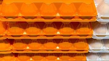 Bright orange egg cartons stacked like industrial honeycombs, evoke sustainability rituals and unconventional storage hacks photo