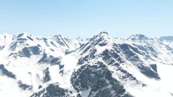 A snow covered mountain range with a clear sky video