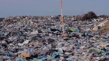 A desolate landfill stretches into the horizon, overflowing with plastic waste and debris, reflecting the environmental crisis we face today video