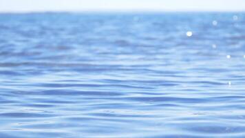 Calm blue sea surface and horizon, slow motion shallow dof video